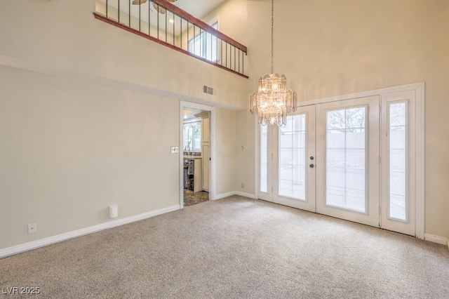 56 Westheimer Rd, Henderson, NV 89074 - carpeted spare room with a chandelier, a high ceiling, and plenty of natural light
