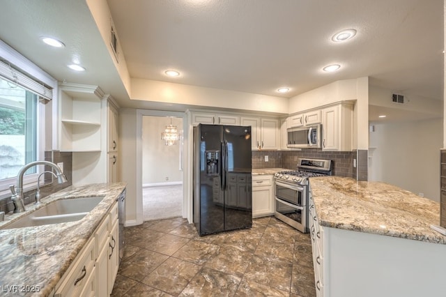 56 Westheimer Rd, Henderson, NV 89074 - kitchen featuring appliances with stainless steel finishes, decorative backsplash, open shelves, light stone countertops, and recessed lighting