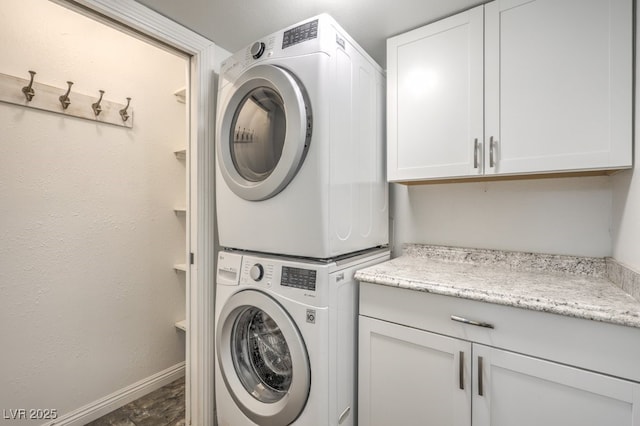 56 Westheimer Rd, Henderson, NV 89074 - laundry area featuring estacked washer and dryer and cabinet space