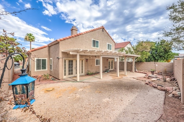 56 Westheimer Rd, Henderson, NV 89074 - rear view of property featuring a chimney, a pergola, stucco siding, a patio area, and a tiled roof