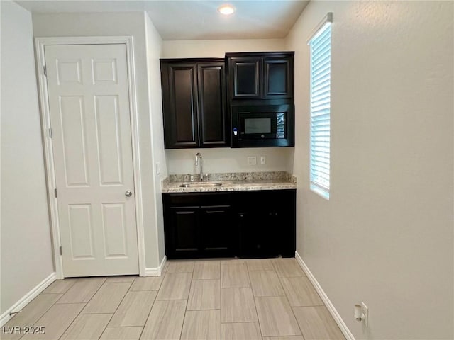4117 Midnight Crest Ave, North Las Vegas, NV 89031 - kitchen with plenty of natural light, black microwave, recessed lighting, and light stone countertops