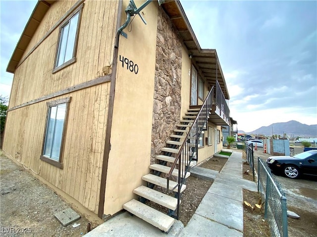 4980 Apollostar Ct, Las Vegas, NV 89115 - view of home's exterior featuring stairway and a mountain view