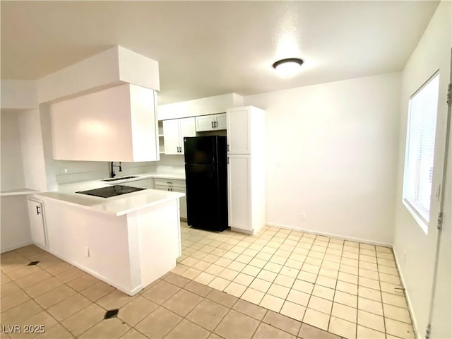 4980 Apollostar Ct, Las Vegas, NV 89115 - kitchen with black appliances, a peninsula, light tile patterned floors, white cabinets, and light countertops