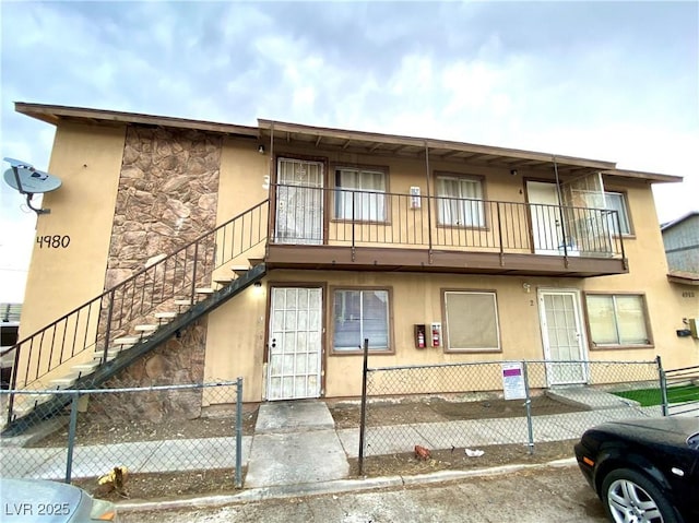 4980 Apollostar Ct, Las Vegas, NV 89115 - view of building exterior with a fenced front yard and stairway