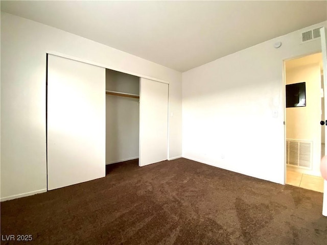 4980 Apollostar Ct, Las Vegas, NV 89115 - unfurnished bedroom featuring dark carpet and a closet