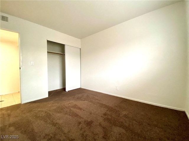 4980 Apollostar Ct, Las Vegas, NV 89115 - unfurnished bedroom featuring dark colored carpet and a closet