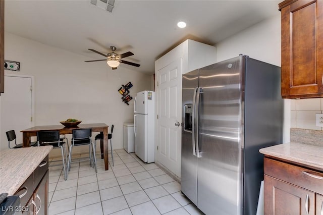 1949 King Hill St, Las Vegas, NV 89106 - kitchen featuring stainless steel fridge with ice dispenser, freestanding refrigerator, ceiling fan, recessed lighting, and light tile patterned floors