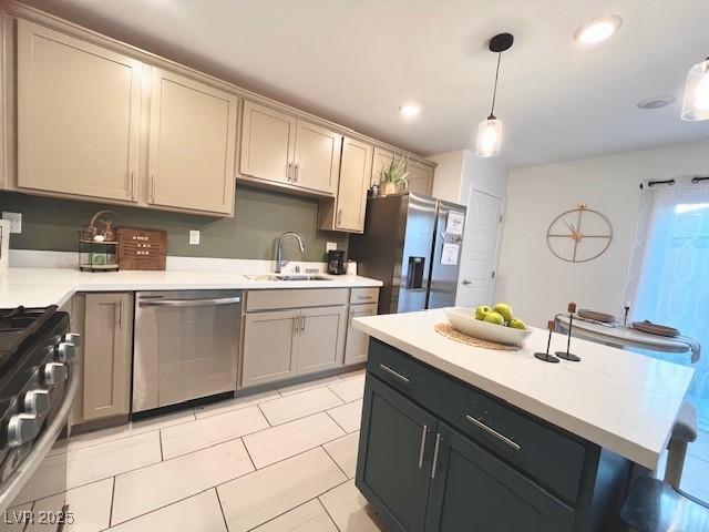 302 Bay Village Pl, Henderson, NV 89011 - kitchen featuring stainless steel appliances, light countertops, hanging light fixtures, gray cabinetry, and light tile patterned floors