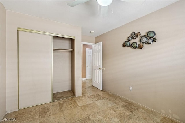 5580 Lonesome Biker Ln, Las Vegas, NV 89113 - unfurnished bedroom with stone finish floors, a closet, and a ceiling fan