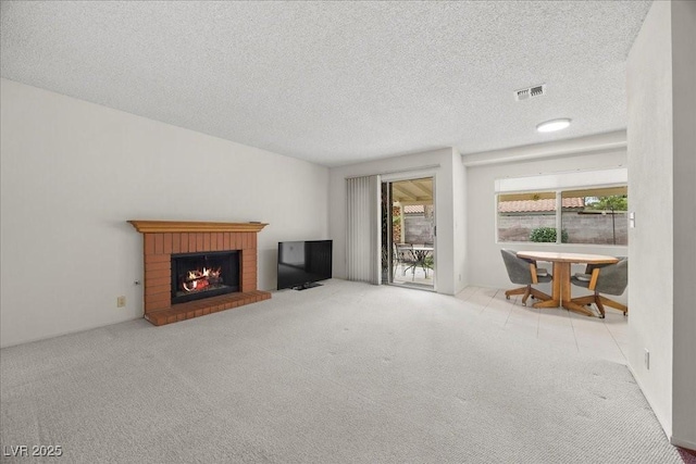 2344 Valleywood St, Henderson, NV 89014 - unfurnished living room featuring carpet floors, a brick fireplace, and a textured ceiling