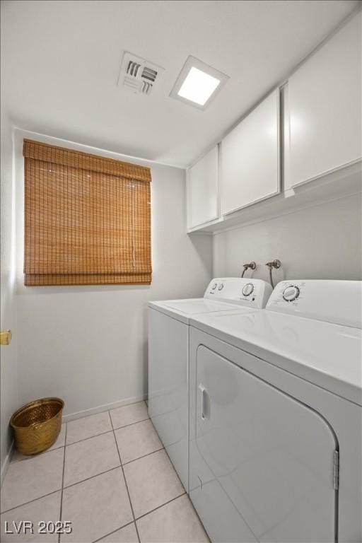 2344 Valleywood St, Henderson, NV 89014 - laundry area with cabinet space, washing machine and clothes dryer, and light tile patterned flooring