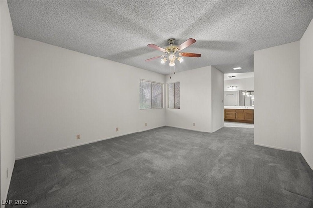 2344 Valleywood St, Henderson, NV 89014 - spare room featuring a ceiling fan, dark carpet, and a textured ceiling