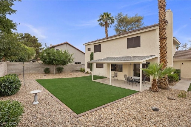 2344 Valleywood St, Henderson, NV 89014 - back of property featuring a fenced backyard, stucco siding, a patio, and a chimney