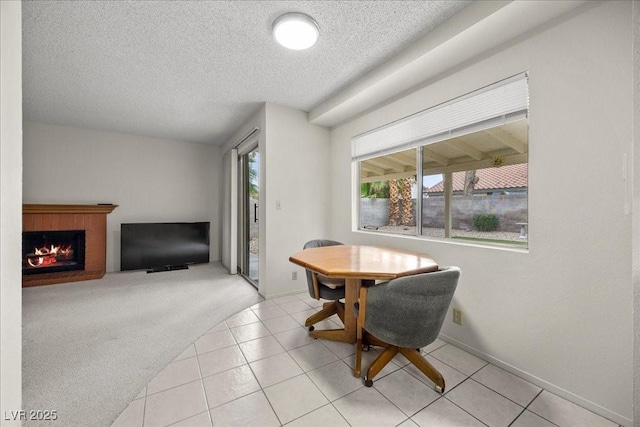 2344 Valleywood St, Henderson, NV 89014 - tiled dining space featuring a textured ceiling and a fireplace