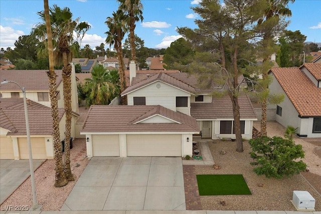 2344 Valleywood St, Henderson, NV 89014 - view of front facade featuring a tiled roof, concrete driveway, a garage, a residential view, and stucco siding