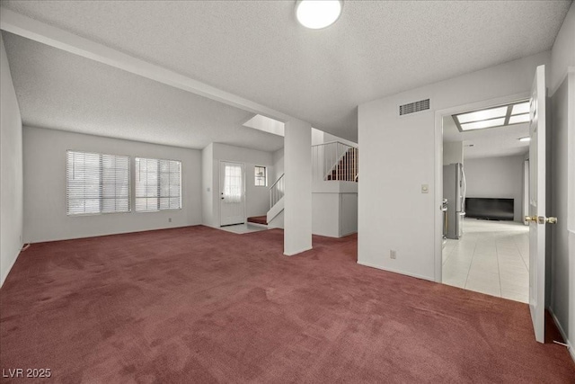 2344 Valleywood St, Henderson, NV 89014 - unfurnished living room with carpet, stairway, a textured ceiling, and tile patterned floors