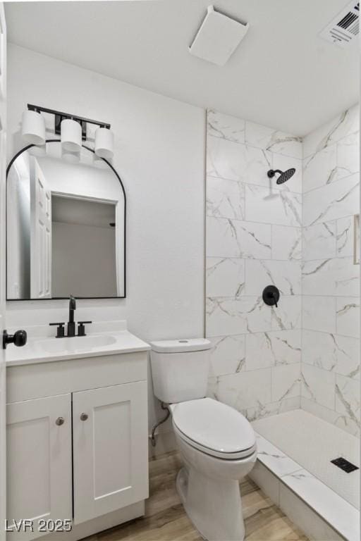 732 N 9th St, Las Vegas, NV 89101 - full bathroom with wood finished floors, vanity, and tiled shower