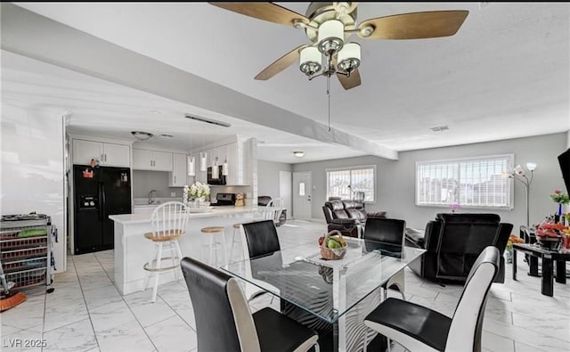 824 Salem Dr, Las Vegas, NV 89107 - dining room with light marble finish floors and a ceiling fan