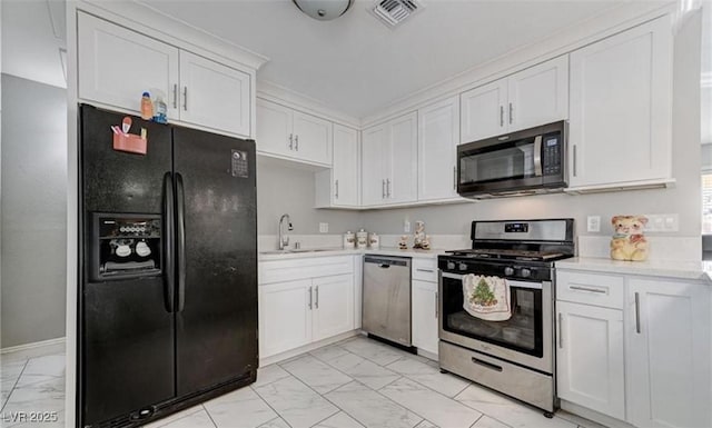 824 Salem Dr, Las Vegas, NV 89107 - kitchen with appliances with stainless steel finishes, light marble finish floors, light countertops, and white cabinetry