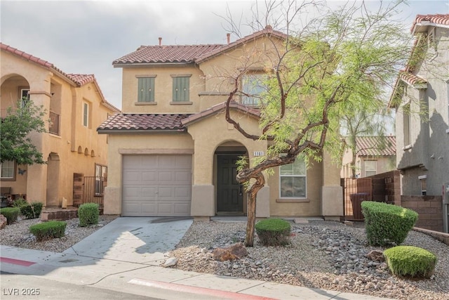 1161 Gecko Rd, Henderson, NV 89002 - mediterranean / spanish-style home featuring a tile roof, stucco siding, an attached garage, and concrete driveway