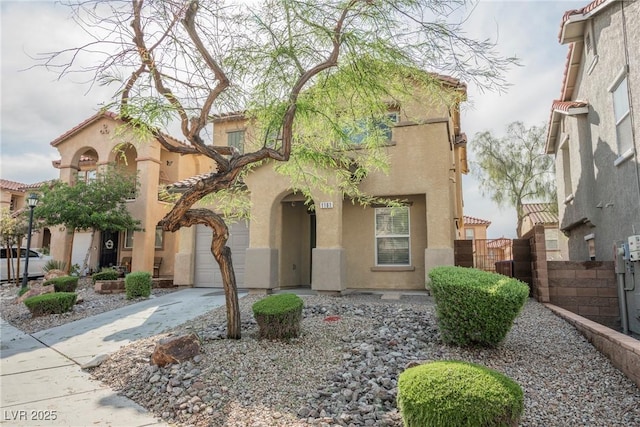 1161 Gecko Rd, Henderson, NV 89002 - mediterranean / spanish-style house with stucco siding, driveway, and an attached garage