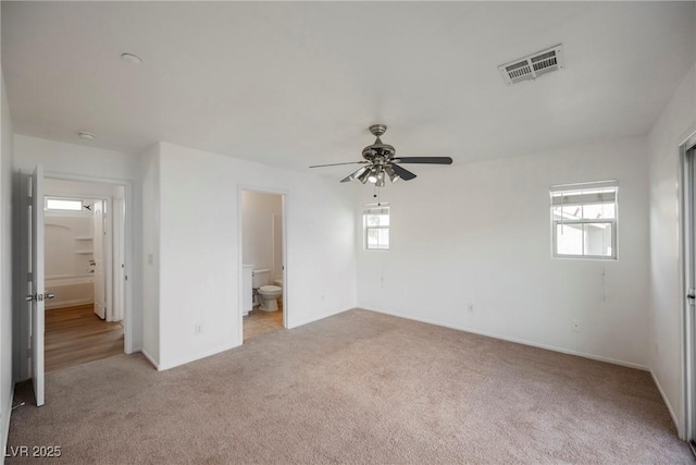 1161 Gecko Rd, Henderson, NV 89002 - unfurnished bedroom featuring light carpet, multiple windows, and ensuite bath