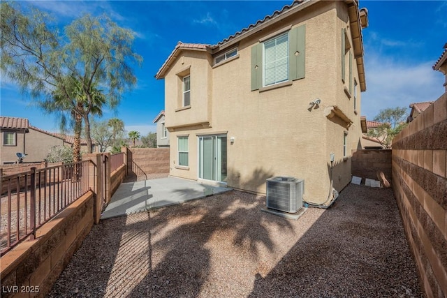 1161 Gecko Rd, Henderson, NV 89002 - rear view of house featuring stucco siding, a patio area, a fenced backyard, and a tile roof