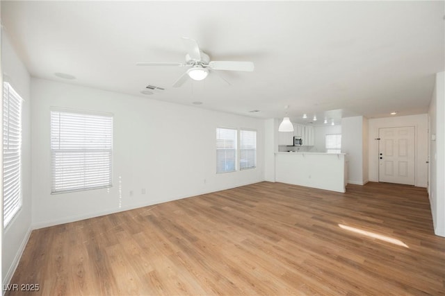 1161 Gecko Rd, Henderson, NV 89002 - unfurnished living room featuring light wood-style floors and a ceiling fan