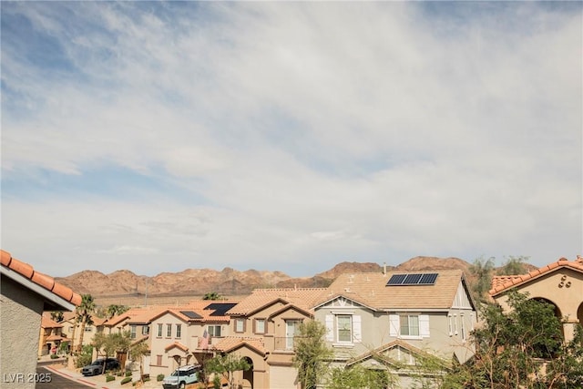 1161 Gecko Rd, Henderson, NV 89002 - view of front of property with a residential view, roof mounted solar panels, a tiled roof, and stucco siding
