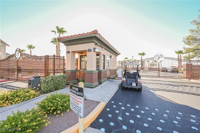 1161 Gecko Rd, Henderson, NV 89002 - view of asphalt road featuring a gate, a gated entry, and curbs