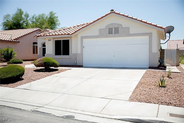 6249 Halehaven Dr, Las Vegas, NV 89110 - mediterranean / spanish-style house with a tile roof, stucco siding, an attached garage, and driveway
