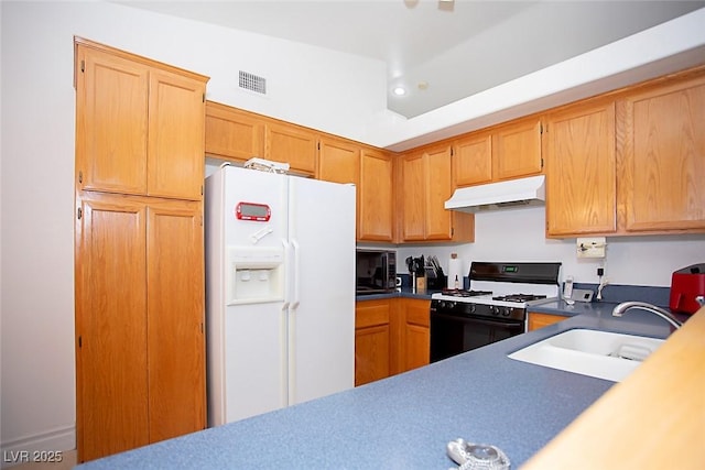 6249 Halehaven Dr, Las Vegas, NV 89110 - kitchen with white fridge with ice dispenser, gas stove, under cabinet range hood, black microwave, and recessed lighting