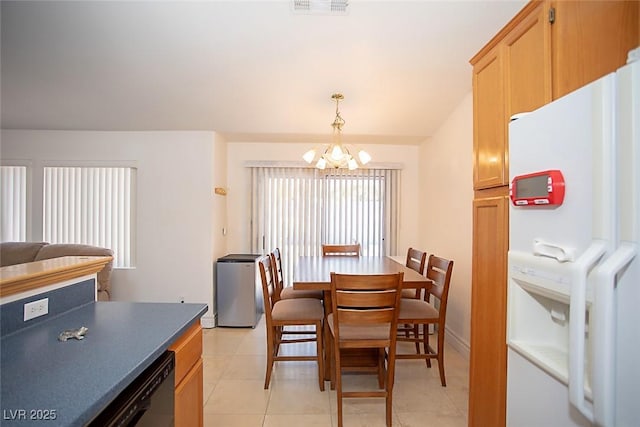 6249 Halehaven Dr, Las Vegas, NV 89110 - dining area featuring a chandelier and light tile patterned flooring