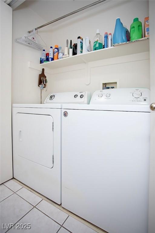 6249 Halehaven Dr, Las Vegas, NV 89110 - laundry area with washing machine and dryer and light tile patterned floors
