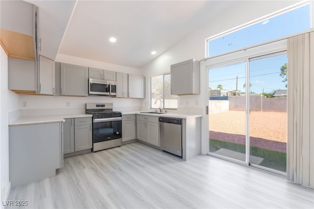 5524 Cleary Ct, Las Vegas, NV 89108 - kitchen featuring stainless steel appliances, gray cabinets, light wood-style flooring, light countertops, and recessed lighting