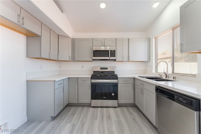 5524 Cleary Ct, Las Vegas, NV 89108 - kitchen featuring appliances with stainless steel finishes, gray cabinets, recessed lighting, light wood-style flooring, and light countertops