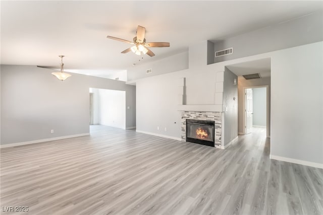 5524 Cleary Ct, Las Vegas, NV 89108 - unfurnished living room featuring lofted ceiling, a ceiling fan, light wood-type flooring, and a stone fireplace