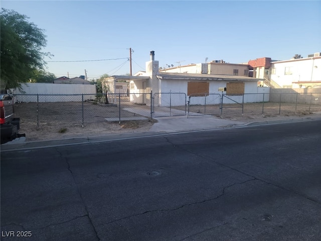 2645 Cedar Ave, Las Vegas, NV 89101 - view of front facade with a chimney, a gate, and stucco siding