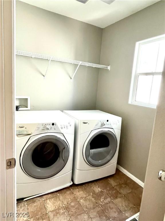 10450 Badger Ravine St, Las Vegas, NV 89178 - laundry area featuring washing machine and clothes dryer and stone finish floors