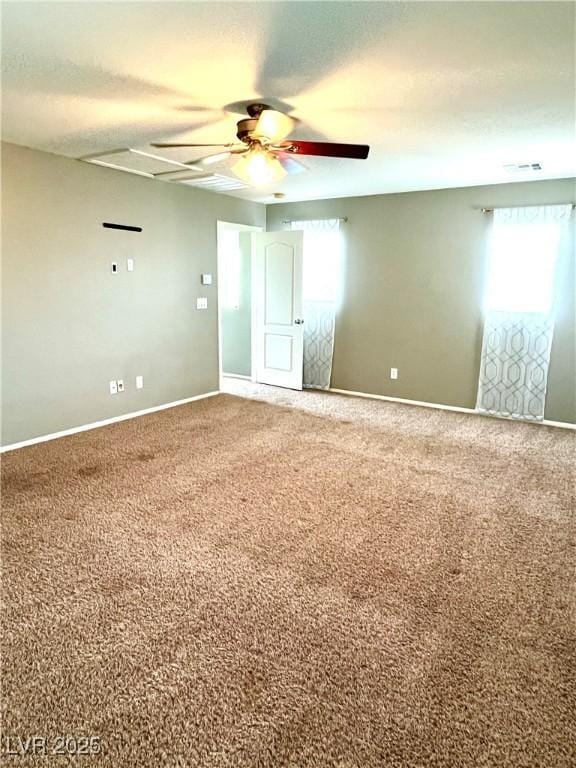 10450 Badger Ravine St, Las Vegas, NV 89178 - empty room featuring a ceiling fan, healthy amount of natural light, and carpet flooring