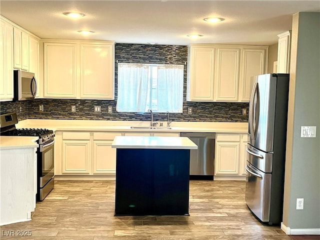 10450 Badger Ravine St, Las Vegas, NV 89178 - kitchen with appliances with stainless steel finishes, backsplash, a kitchen island, and light countertops