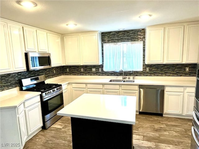 10450 Badger Ravine St, Las Vegas, NV 89178 - kitchen with appliances with stainless steel finishes, backsplash, light countertops, and white cabinets