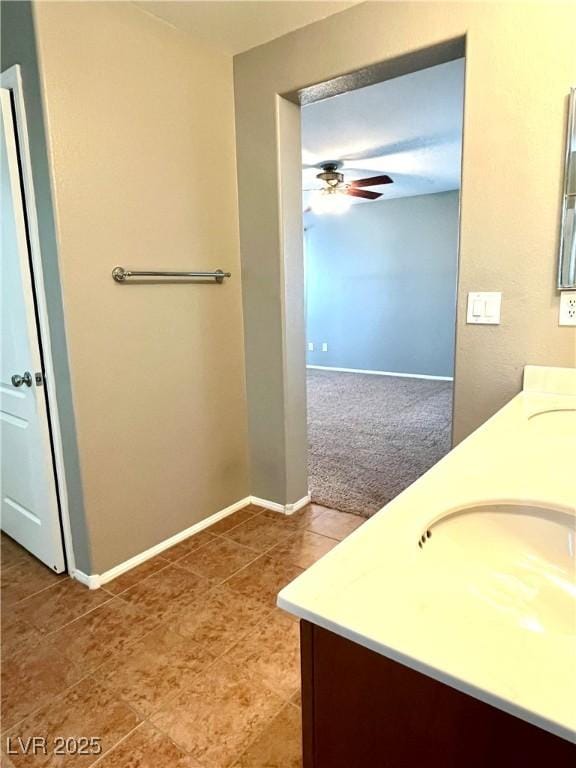 10450 Badger Ravine St, Las Vegas, NV 89178 - bathroom with double vanity, ceiling fan, and tile patterned floors
