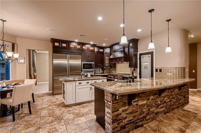 9583 Gainey Ranch Ave, Las Vegas, NV 89147 - kitchen featuring built in appliances, decorative backsplash, premium range hood, a chandelier, and recessed lighting