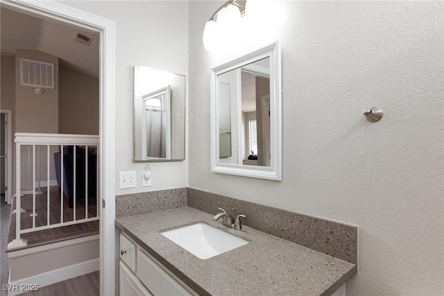 9836 Russett Wood Cir, Las Vegas, NV 89117 - bathroom with vanity and wood finished floors
