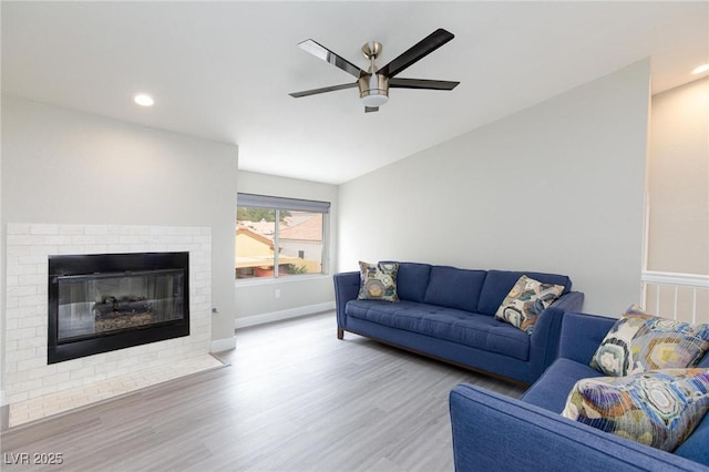 9836 Russett Wood Cir, Las Vegas, NV 89117 - living room featuring ceiling fan, wood finished floors, a fireplace, and recessed lighting