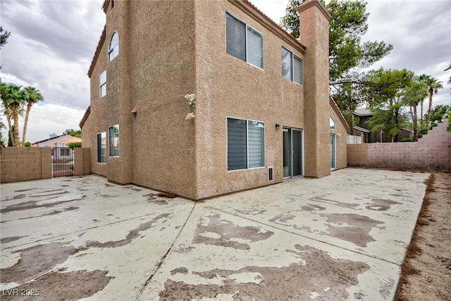 9836 Russett Wood Cir, Las Vegas, NV 89117 - back of house featuring a patio area, stucco siding, and a fenced backyard