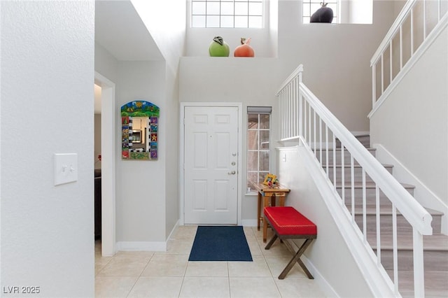 9836 Russett Wood Cir, Las Vegas, NV 89117 - entrance foyer with tile patterned flooring, stairs, and a towering ceiling