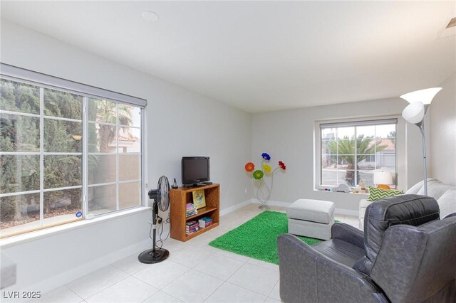 9836 Russett Wood Cir, Las Vegas, NV 89117 - living room featuring healthy amount of natural light and light tile patterned flooring