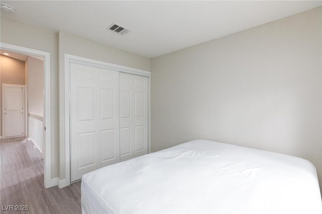 9836 Russett Wood Cir, Las Vegas, NV 89117 - bedroom featuring wood finished floors and a closet